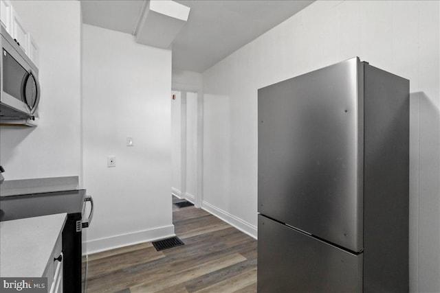 18 Belview Ave, Hagerstown, MD 21742 - kitchen featuring appliances with stainless steel finishes, dark wood-type flooring, white cabinets, and light countertops