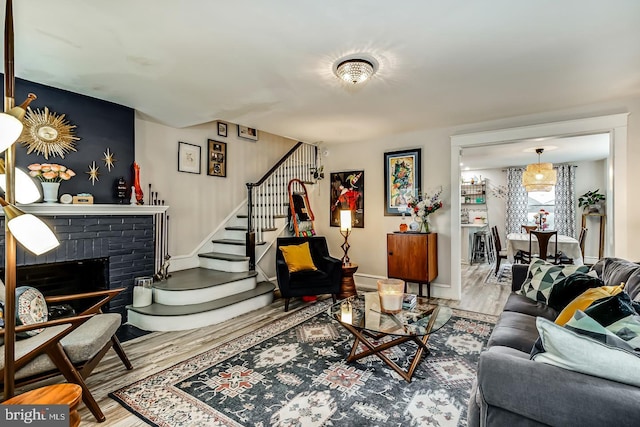 15 Willowbrook Ave, Lansdowne, PA 19050 - living room featuring wood finished floors, stairs, and a brick fireplace