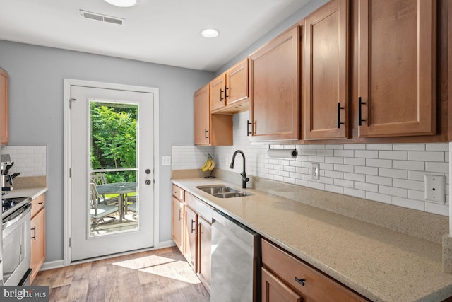 121 Westpoint Dr, Carlisle, PA 17013 - kitchen featuring appliances with stainless steel finishes, light wood-style floors, tasteful backsplash, light stone counters, and recessed lighting