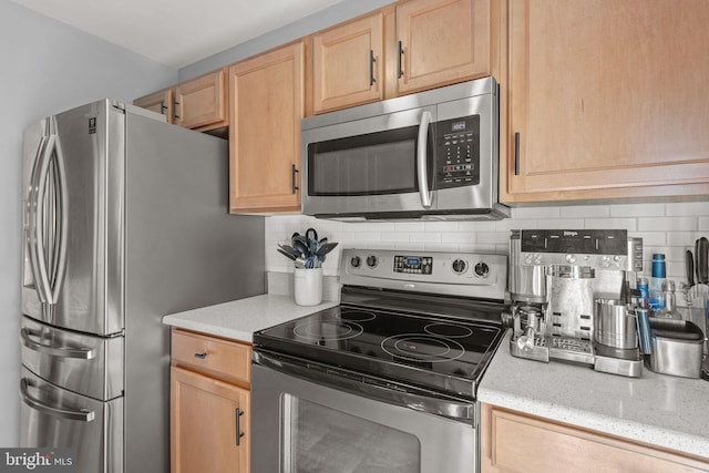 121 Westpoint Dr, Carlisle, PA 17013 - kitchen featuring stainless steel appliances, light brown cabinetry, tasteful backsplash, and light stone counters