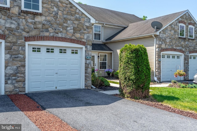 121 Westpoint Dr, Carlisle, PA 17013 - multi unit property with stone siding, driveway, a garage, and a shingled roof
