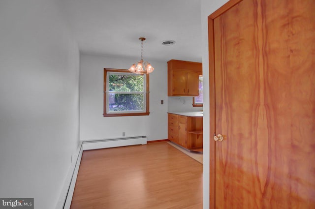 21024 Jefferson Blvd, Smithsburg, MD 21783 - unfurnished dining area featuring light wood-style floors, baseboard heating, and a chandelier