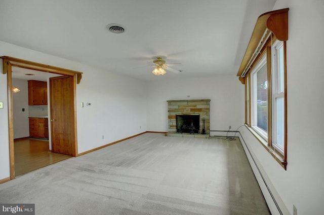 21024 Jefferson Blvd, Smithsburg, MD 21783 - unfurnished living room with ceiling fan, light carpet, a stone fireplace, and baseboard heating