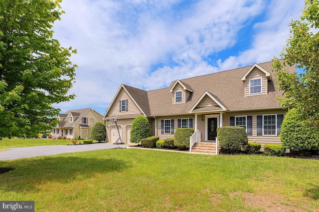 24750 Peterkins Rd, Georgetown, DE 19947 - cape cod house with driveway, a front yard, and a shingled roof