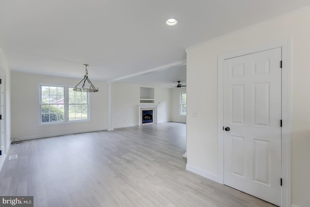 24750 Peterkins Rd, Georgetown, DE 19947 - unfurnished living room featuring light wood-style floors, a fireplace, recessed lighting, ceiling fan, and crown molding