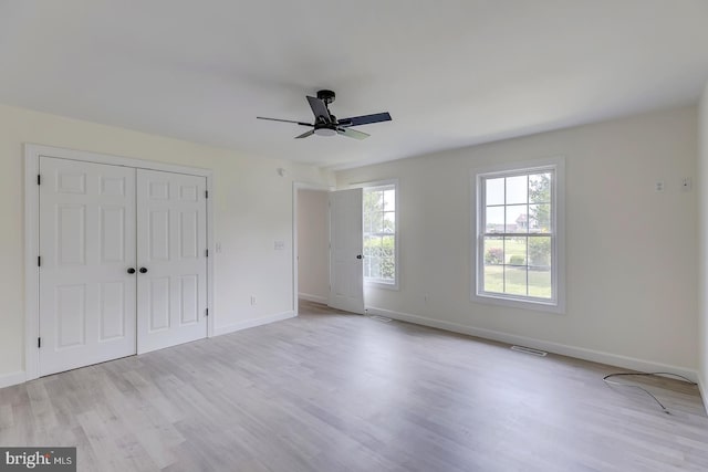 24750 Peterkins Rd, Georgetown, DE 19947 - unfurnished bedroom with light wood-type flooring, a closet, and ceiling fan