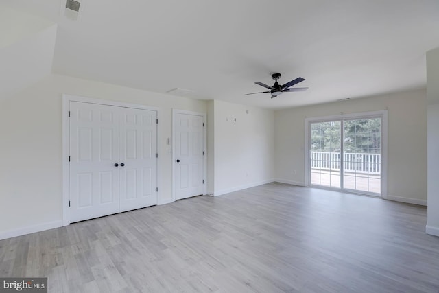24750 Peterkins Rd, Georgetown, DE 19947 - unfurnished bedroom featuring access to exterior, wood finished floors, a ceiling fan, and multiple closets