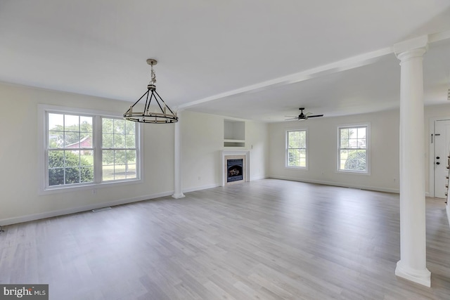 24750 Peterkins Rd, Georgetown, DE 19947 - unfurnished living room featuring ornate columns, wood finished floors, a chandelier, a ceiling fan, and a fireplace