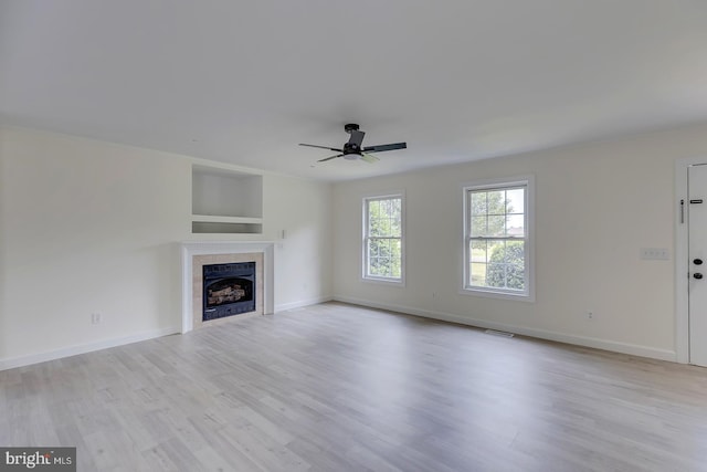 24750 Peterkins Rd, Georgetown, DE 19947 - unfurnished living room featuring ceiling fan, a fireplace, and light wood-style flooring