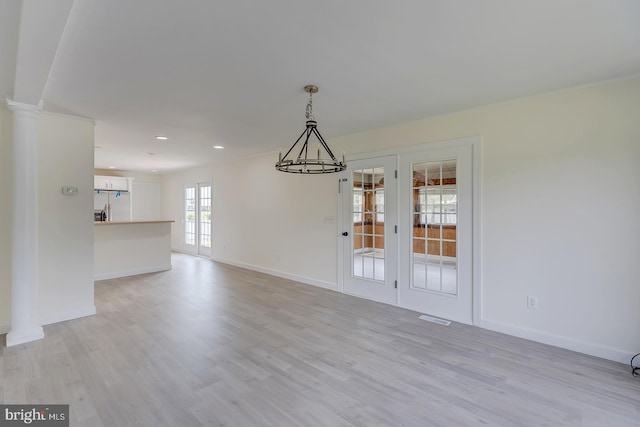 24750 Peterkins Rd, Georgetown, DE 19947 - unfurnished dining area featuring light wood finished floors, recessed lighting, a chandelier, and decorative columns