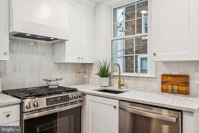 1935 S Hemberger St, Philadelphia, PA 19145 - kitchen featuring appliances with stainless steel finishes, custom exhaust hood, white cabinetry, and tasteful backsplash