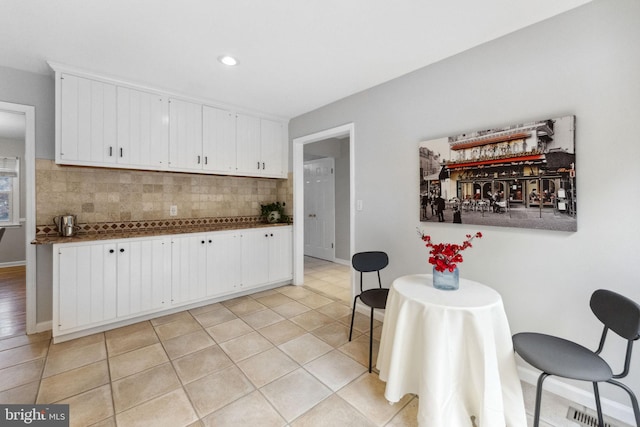 12 Stonelea Dr, Princeton Junction, NJ 08550 - kitchen with dark countertops, decorative backsplash, white cabinets, light tile patterned flooring, and recessed lighting