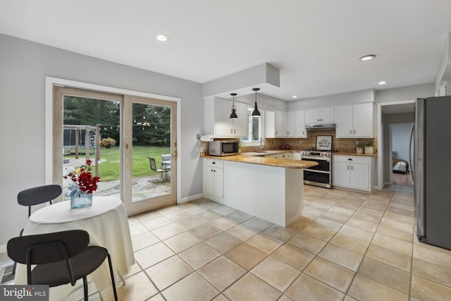 12 Stonelea Dr, Princeton Junction, NJ 08550 - kitchen featuring stainless steel appliances, a peninsula, white cabinetry, decorative backsplash, and healthy amount of natural light