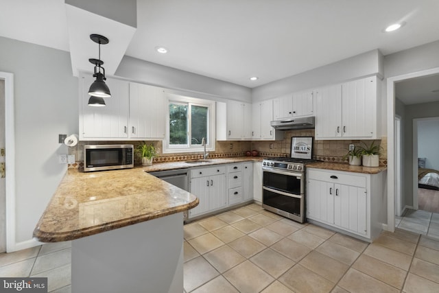 12 Stonelea Dr, Princeton Junction, NJ 08550 - kitchen featuring appliances with stainless steel finishes, under cabinet range hood, a peninsula, white cabinets, and recessed lighting