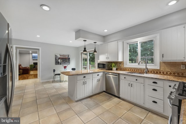 12 Stonelea Dr, Princeton Junction, NJ 08550 - kitchen featuring appliances with stainless steel finishes, a peninsula, decorative backsplash, white cabinets, and recessed lighting