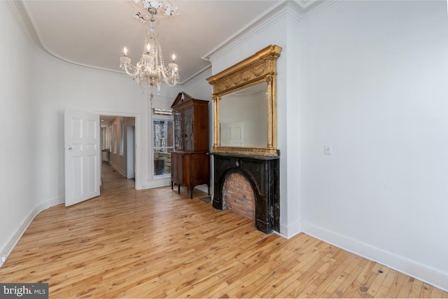 525 Scott St, Baltimore, MD 21230 - unfurnished living room featuring ornamental molding, a chandelier, hardwood / wood-style flooring, and a large fireplace