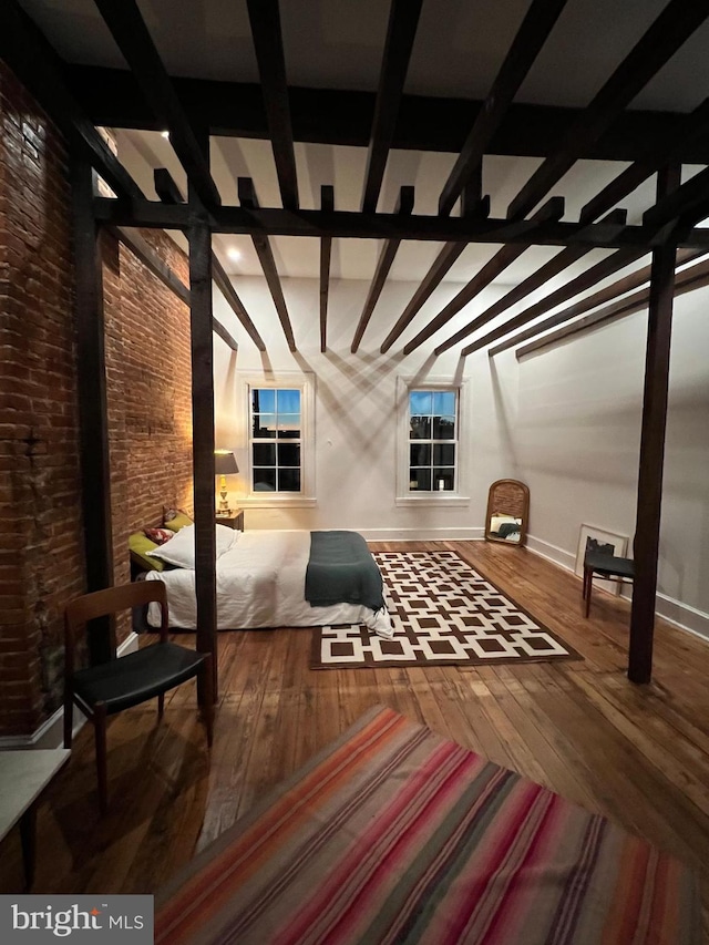 525 Scott St, Baltimore, MD 21230 - bonus room with wood-type flooring, beamed ceiling, and brick wall