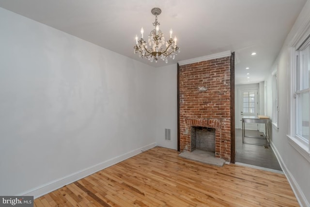 525 Scott St, Baltimore, MD 21230 - unfurnished living room with wood finished floors, a chandelier, a brick fireplace, and recessed lighting