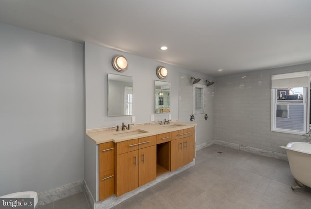 525 Scott St, Baltimore, MD 21230 - bathroom featuring double vanity, a soaking tub, tile patterned floors, tiled shower, and recessed lighting