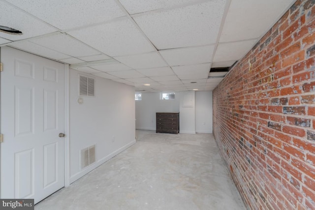 525 Scott St, Baltimore, MD 21230 - basement featuring a paneled ceiling and brick wall