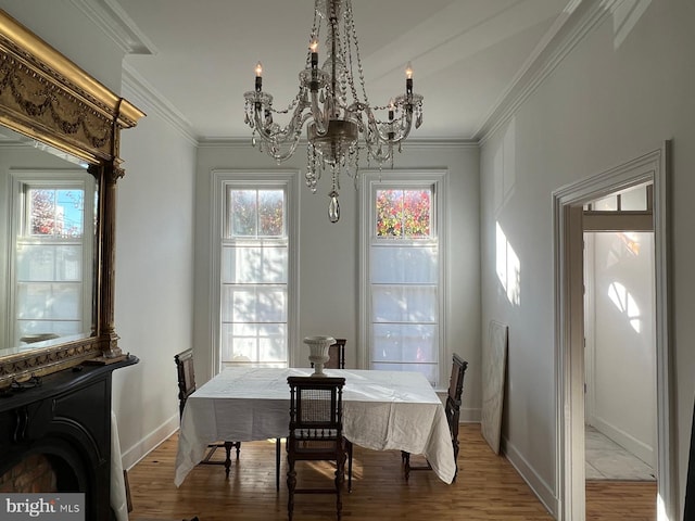 525 Scott St, Baltimore, MD 21230 - dining area featuring a chandelier, crown molding, and light wood finished floors