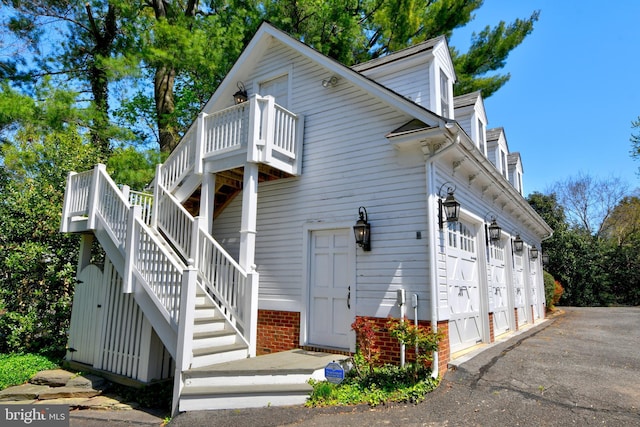 3634 Chain Bridge Rd, Fairfax, VA 22030 - view of property exterior featuring stairs, driveway, and an attached garage