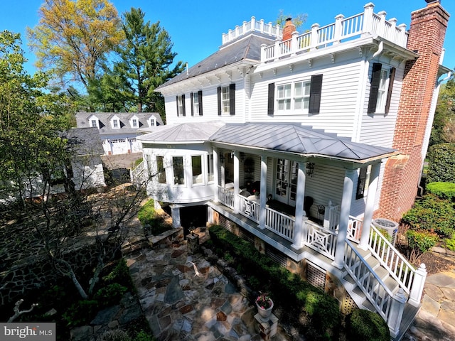 3634 Chain Bridge Rd, Fairfax, VA 22030 - view of front facade with a porch, a standing seam roof, french doors, a metal roof, and a chimney