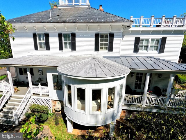 3634 Chain Bridge Rd, Fairfax, VA 22030 - back of property featuring a porch, a standing seam roof, a metal roof, and stairway