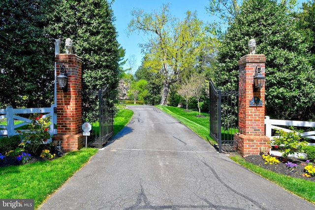 3634 Chain Bridge Rd, Fairfax, VA 22030 - view of asphalt driveway featuring a gate, view of scattered trees, and a gated entry