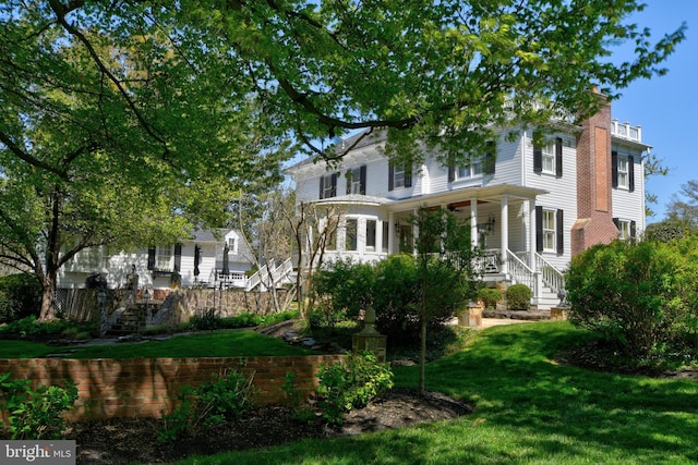 3634 Chain Bridge Rd, Fairfax, VA 22030 - view of front facade with stairway, covered porch, a chimney, and a front yard