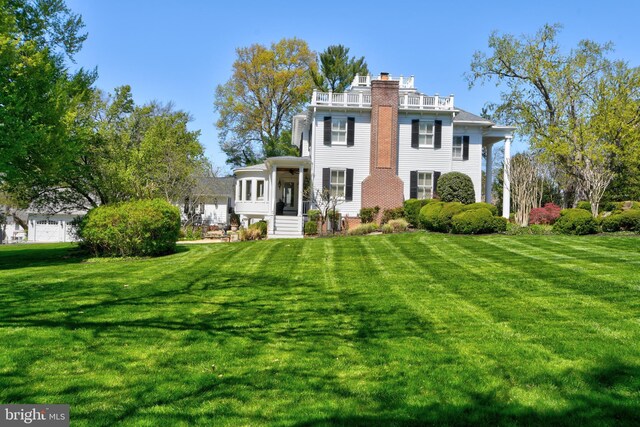 3634 Chain Bridge Rd, Fairfax, VA 22030 - view of front of home featuring a balcony, a front yard, and a chimney