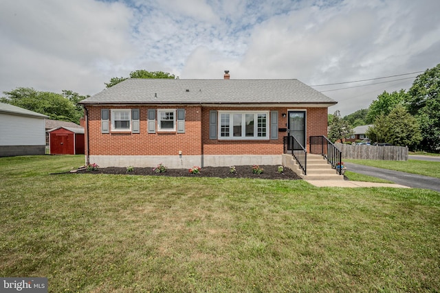 2811 Green St, Claymont, DE 19703 - view of front of property with brick siding, a storage unit, a front lawn, and a chimney