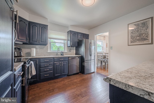 2811 Green St, Claymont, DE 19703 - kitchen featuring stainless steel appliances, plenty of natural light, dark wood finished floors, and backsplash