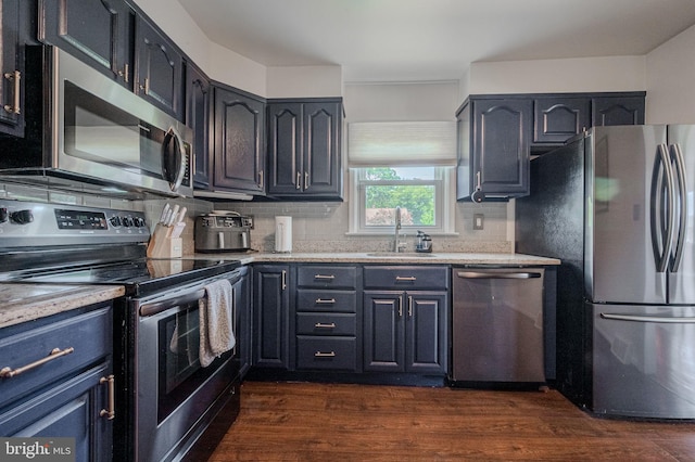 2811 Green St, Claymont, DE 19703 - kitchen with stainless steel appliances, tasteful backsplash, and dark wood-type flooring