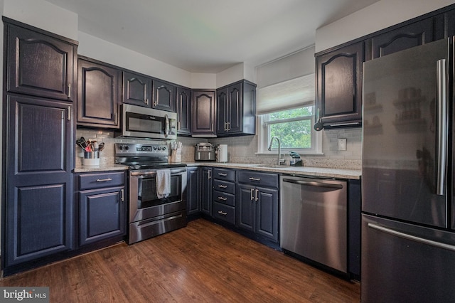 2811 Green St, Claymont, DE 19703 - kitchen with stainless steel appliances, dark wood-style flooring, and backsplash