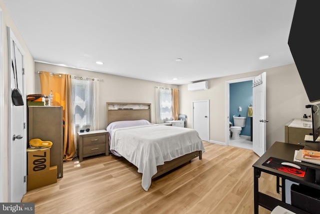 510 Sutherland Rd, Ewing, NJ 08618 - bedroom featuring a wall unit AC, light wood-style floors, recessed lighting, and ensuite bathroom