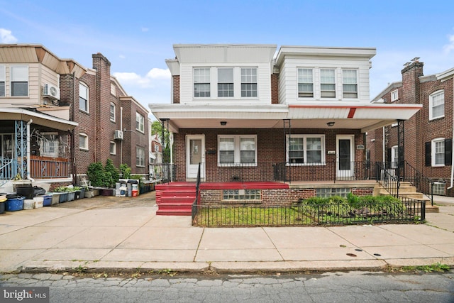 7019 Algard St, Philadelphia, PA 19135 - townhome / multi-family property with covered porch, a fenced front yard, and brick siding
