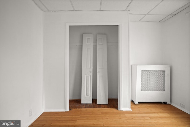 7019 Algard St, Philadelphia, PA 19135 - unfurnished bedroom featuring wood finished floors, a paneled ceiling, and heating unit