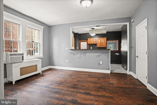 7019 Algard St, Philadelphia, PA 19135 - unfurnished living room featuring radiator, plenty of natural light, and wood finished floors