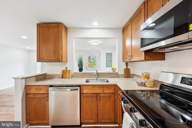 24 Whitechurch Ct, Germantown, MD 20874 - kitchen with stainless steel appliances, brown cabinets, light countertops, recessed lighting, and light wood-style floors