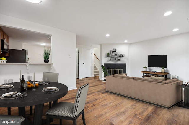 24 Whitechurch Ct, Germantown, MD 20874 - living room with light wood finished floors, stairway, recessed lighting, and a glass covered fireplace
