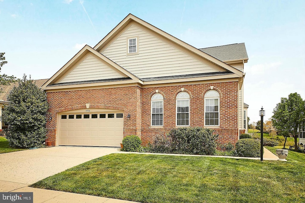 13736 Charismatic Way, Gainesville, VA 20155 - view of front facade with brick siding, a front yard, concrete driveway, and an attached garage