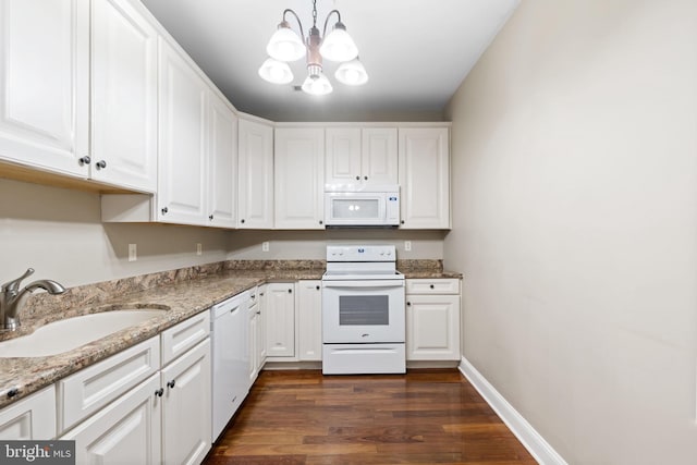 1324 W Chester Pike Unit 105, West Chester, PA 19382 - kitchen featuring white appliances, white cabinetry, dark wood-style floors, a chandelier, and pendant lighting
