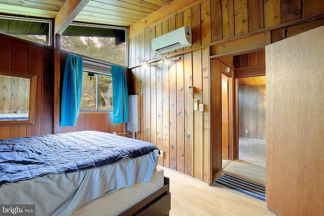 638 Los Alamos Ln, Lusby, MD 20657 - bedroom featuring an AC wall unit, wood walls, wood finished floors, and wooden ceiling