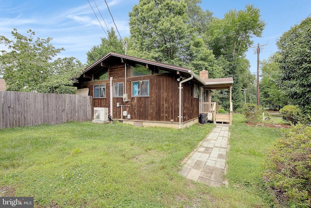 638 Los Alamos Ln, Lusby, MD 20657 - view of side of home with a chimney and a cooling unit