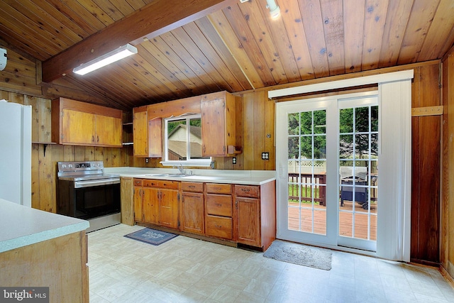 638 Los Alamos Ln, Lusby, MD 20657 - kitchen with stainless steel electric range oven, light flooring, light countertops, healthy amount of natural light, and wood walls