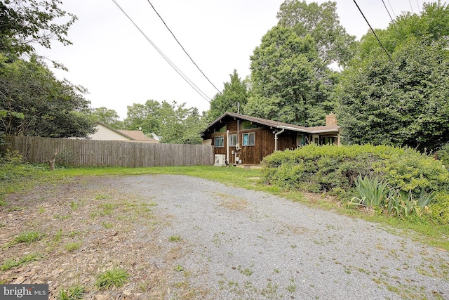 638 Los Alamos Ln, Lusby, MD 20657 - view of property exterior featuring a chimney and gravel driveway
