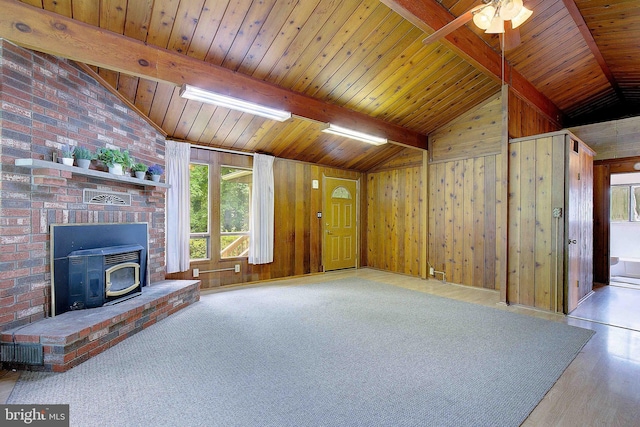 638 Los Alamos Ln, Lusby, MD 20657 - unfurnished living room with a wood stove, wooden walls, wooden ceiling, a ceiling fan, and wood finished floors