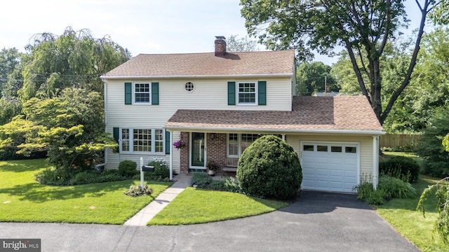 559 Maple Ave, Doylestown, PA 18901 - view of front of property featuring an attached garage, asphalt driveway, a chimney, a front lawn, and a shingled roof