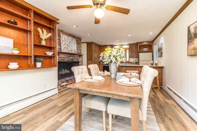 559 Maple Ave, Doylestown, PA 18901 - dining space with a baseboard radiator, a baseboard heating unit, light wood finished floors, ceiling fan, and crown molding